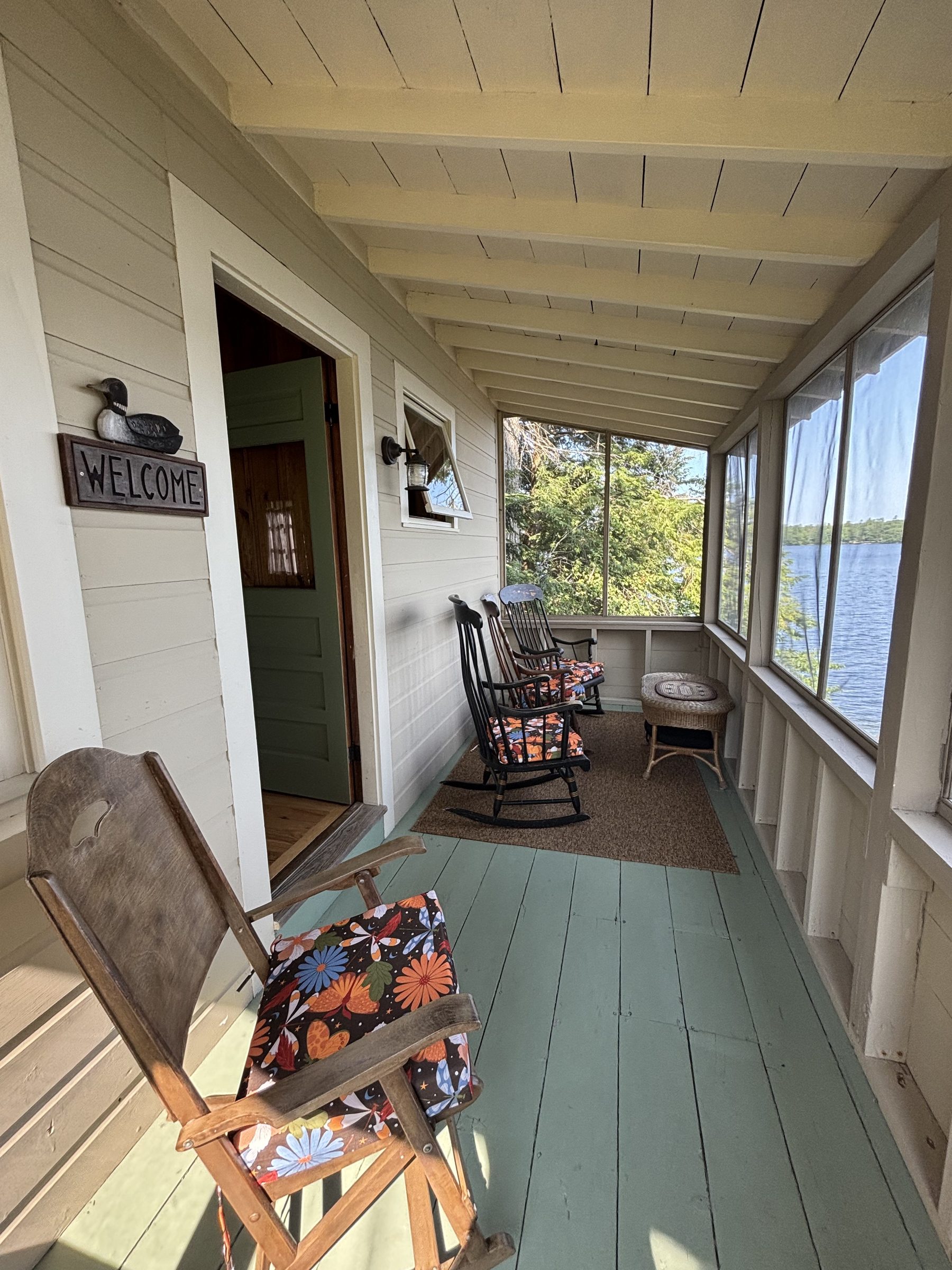 Harmony cabin screened porch with welcome sign
