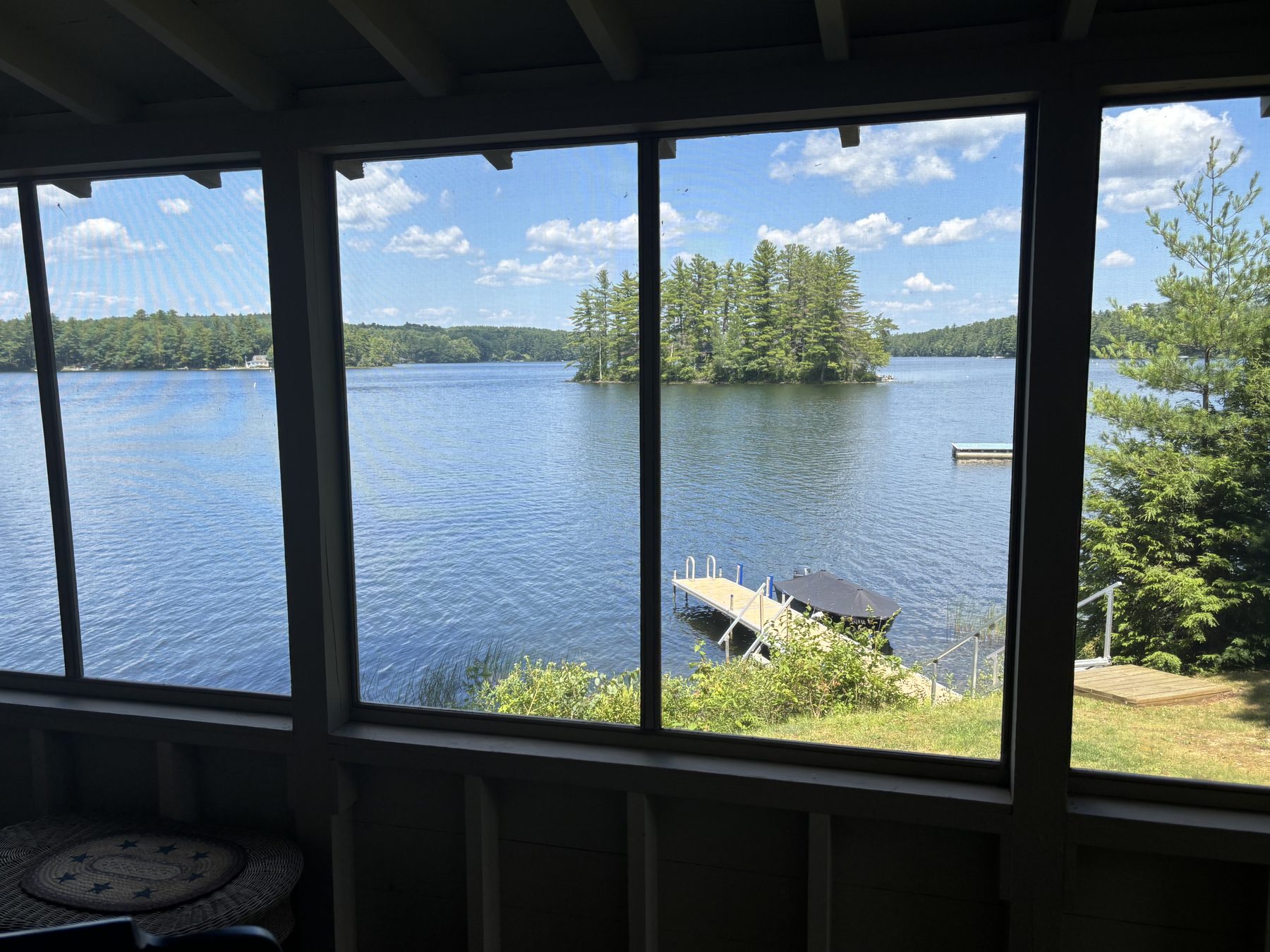 View of a small island and dock from the screened porch