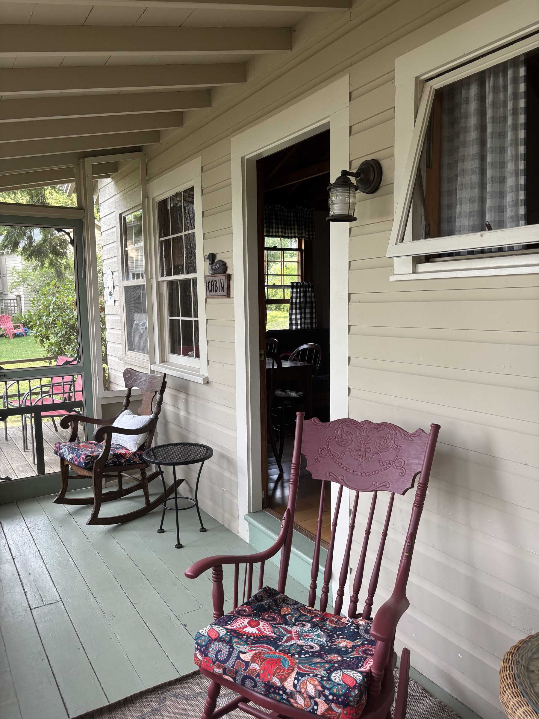 Serenity cabin screened porch with rocking chairs
